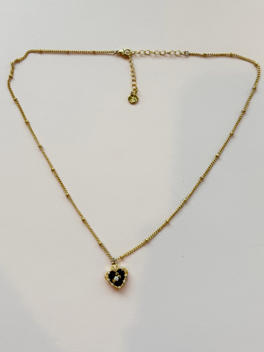 Gold-Tone Necklace with Black Heart Pendant